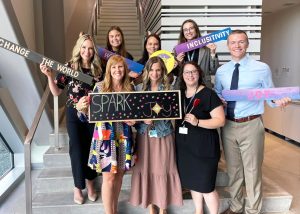 Staff from Waukee Community School District hold positivity signs