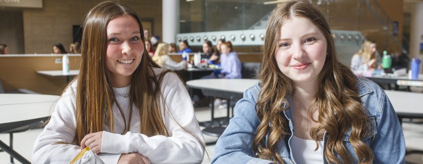 Two Female Students Smiling at Camera