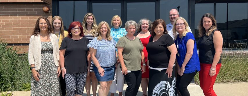 Photos of the Waukee CSD Business Office team outside the District Office.