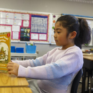 Elementary student reading.