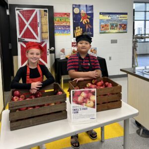 Two students serving appleas.