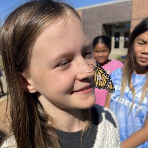 Student with a butterfly on her nose.