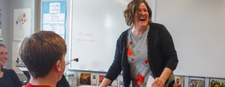 Teacher laughing during language class.