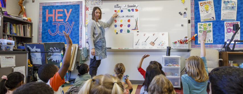 Art teacher reviewing colors with kindergarteners