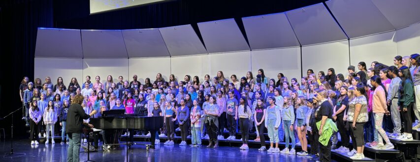 Jennifer Ghelf directing students on stage.