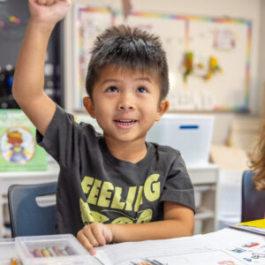 student raising his hand