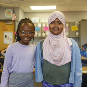 Two students smiling