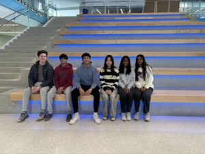 Group of students sitting and smiling.