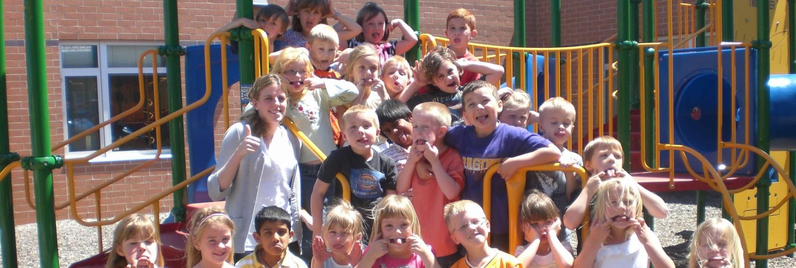 Young students make funny faces on a playground.