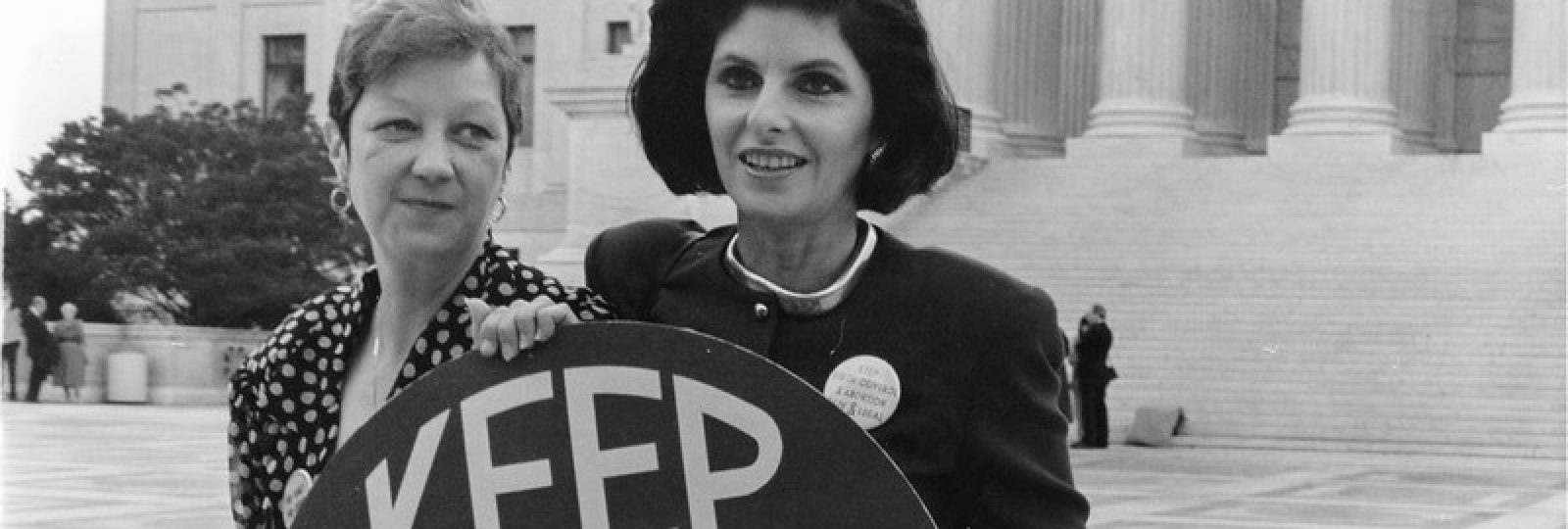 Two women hold a sign reading Keep Abortion Legal