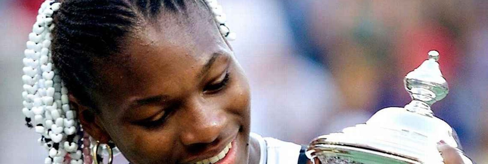 Serena Williams holds a trophy